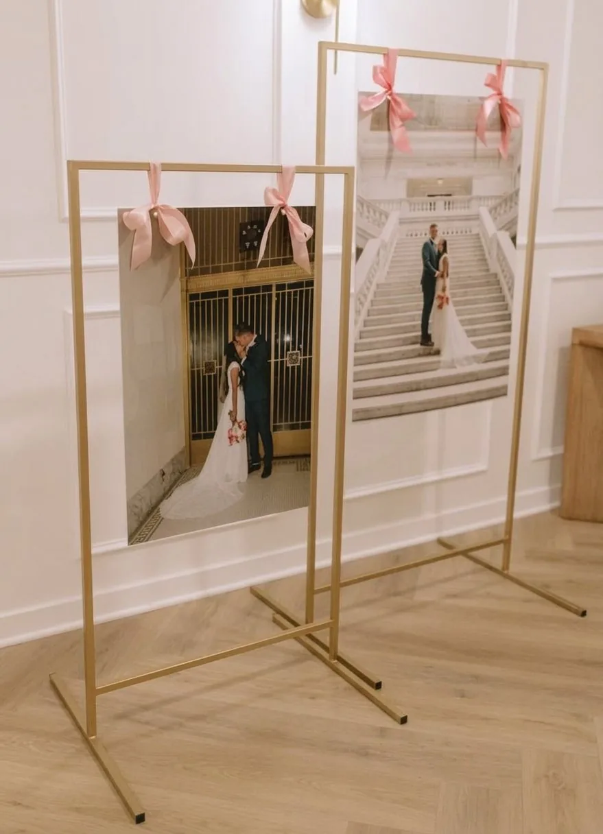 Large and small gold display stands at a wedding venue
